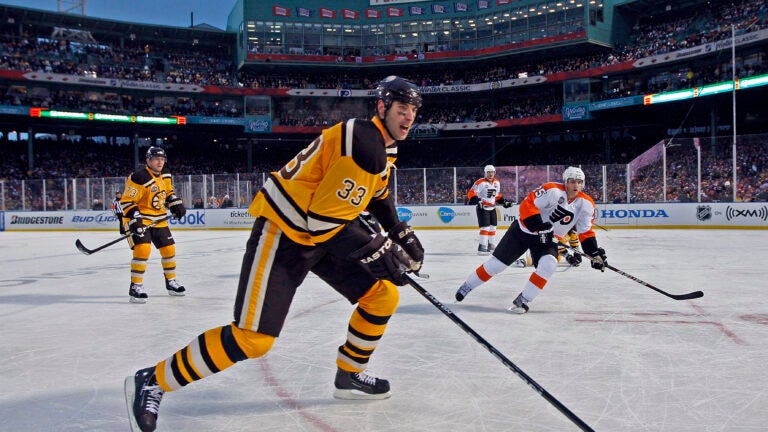 Boston Bruins defenseman Zdeno Chara, of Slovakia, waves alongside