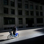 A cyclist pedals his way down Arch Street in Boston.