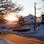 The sun rises on a snow covered scene in Medford.