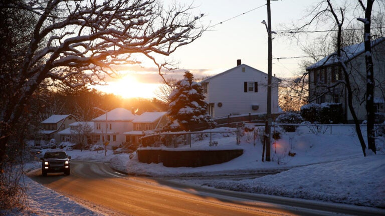 The sun rises on a snow covered scene in Medford.