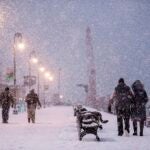 People walk through heavy snow fall in the Navy Yard during a winter storm.
