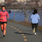 Runners along Memorial Drive in Cambridge.
