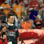 Tom Brady hoists the Vince Lombardi Trophy.
