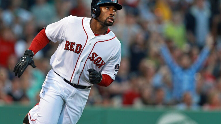 Jackie Bradley Jr. #19 of the Boston Red Sox looses his hat as he