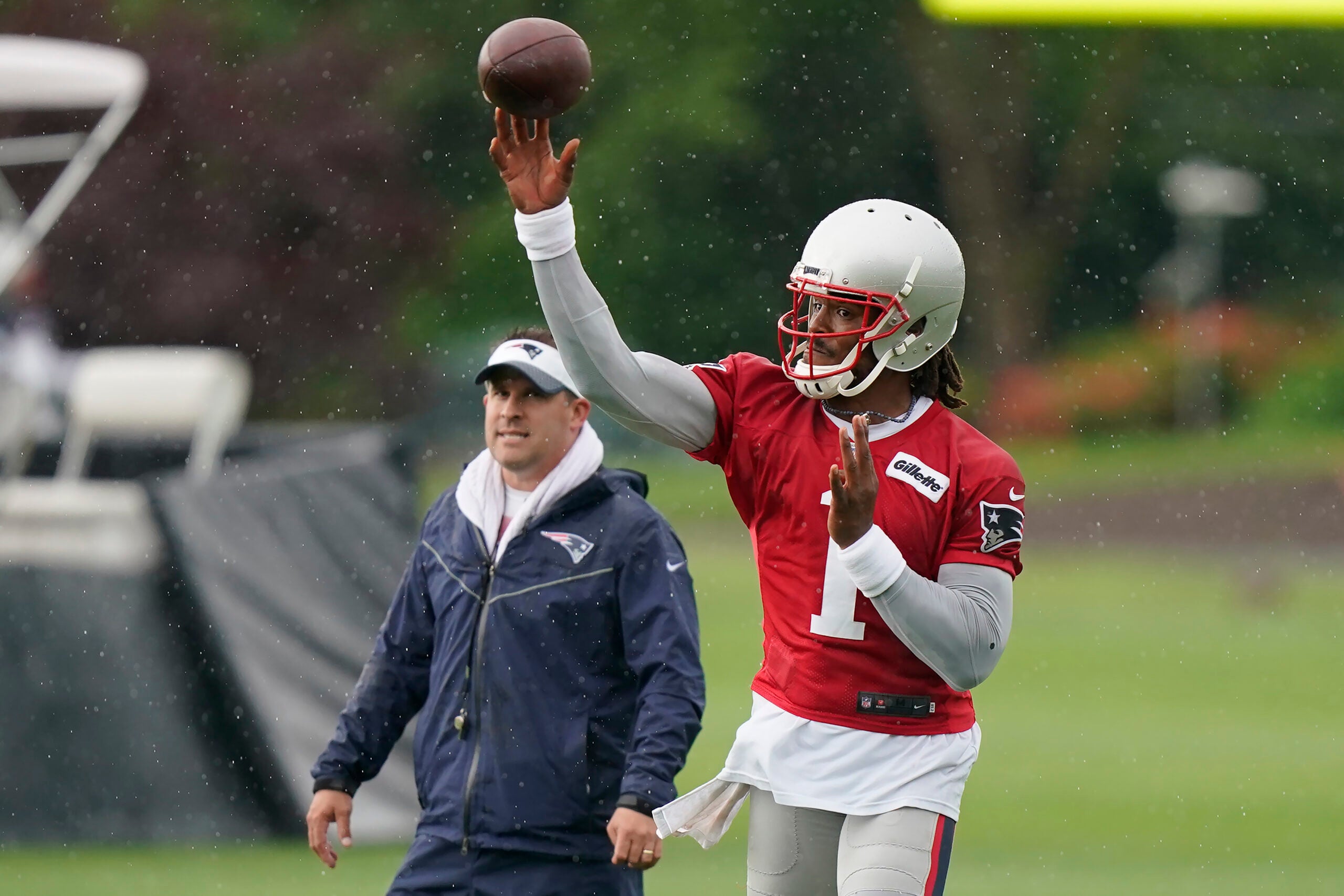 Cam Newton of the New England Patriots throws the ball in the second