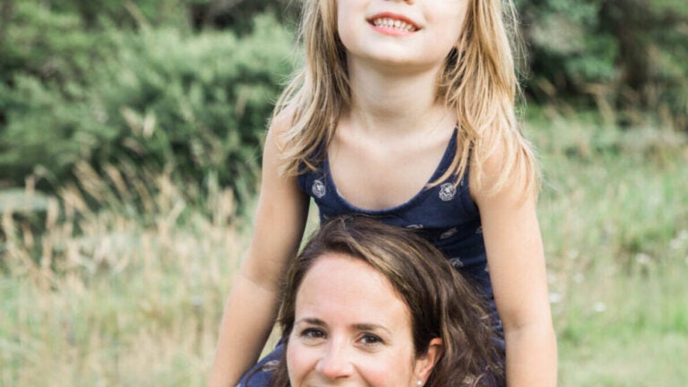 Grace Hull carries her daughter on her shoulders