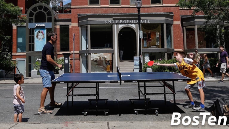 David Gilo and his son Nicholas Play ping pong in the middle of Newbury Street