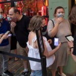 A customer shows her vaccination card to a host at City Winery, a restaurant in New York, on May 26, 2021