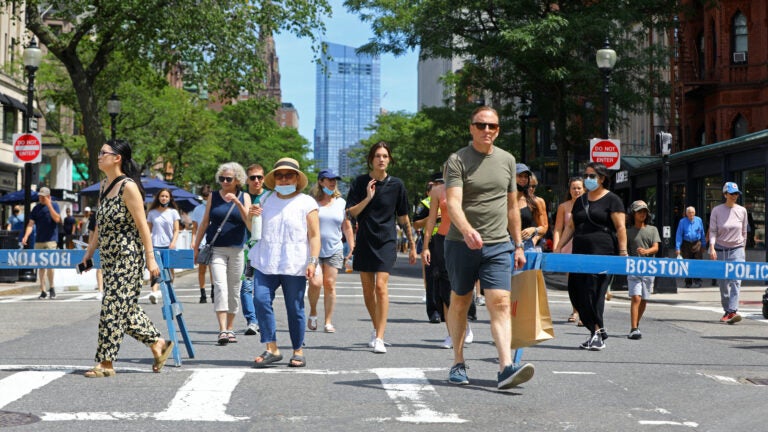 A group of people walking around a mall photo – Free Boston Image