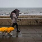 Woman-Walking-Dog-In-Storm
