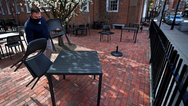 Ristorante Lucia restaurant's owner, Philip Frattaroli sets up tables in the courtyard