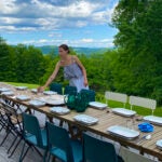 Sommelier Amanda Geller helps prepare the table at Esmeralda restaurant in Andover, Vermont