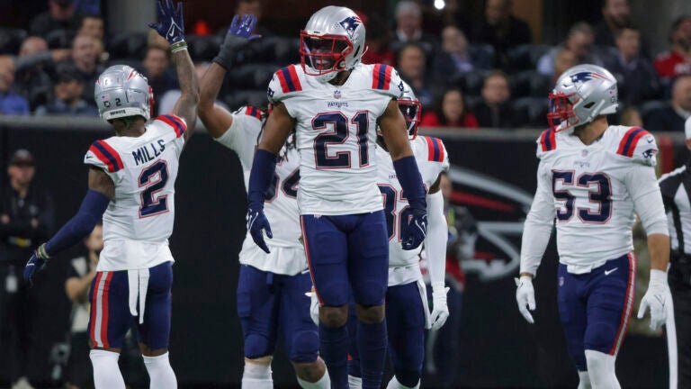 New England Patriots' dominant defense tames Giants to stay