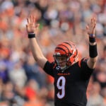 Cincinnati Bengals quarterback Joe Burrow (9) reacts after a touchdown run by Joe Mixon during the first half of an NFL football game against the Baltimore Ravens, Sunday, Dec. 26, 2021, in Cincinnati.