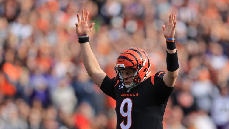 Cincinnati Bengals quarterback Joe Burrow (9) reacts after a touchdown run by Joe Mixon during the first half of an NFL football game against the Baltimore Ravens, Sunday, Dec. 26, 2021, in Cincinnati.