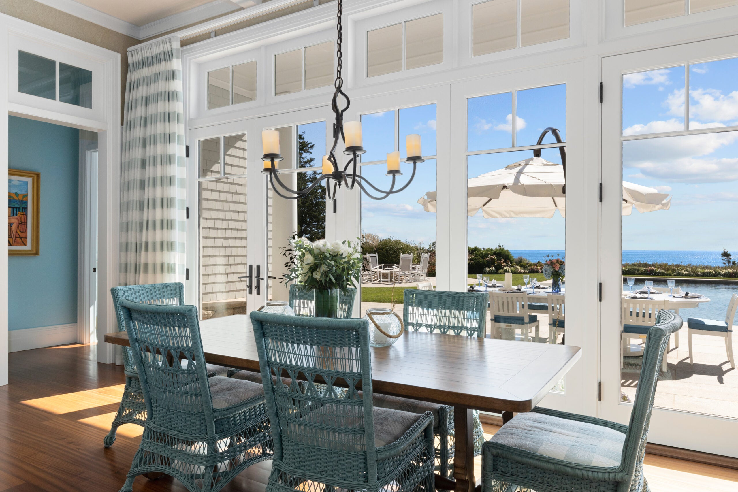 A close-up of the view from the dining area with the blue wicker chairs.