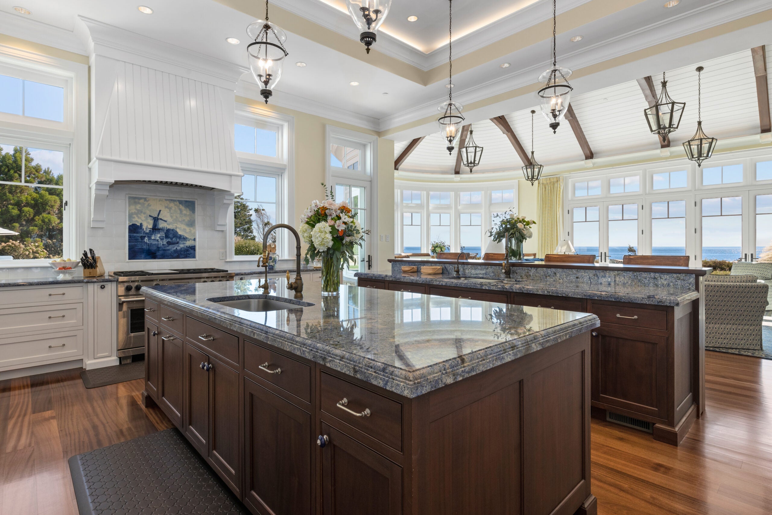 A look from within the kitchen. The two islands are the main focus. Both have sinks. In the background is the breakfast nook and the family room and beyond that the ocean.