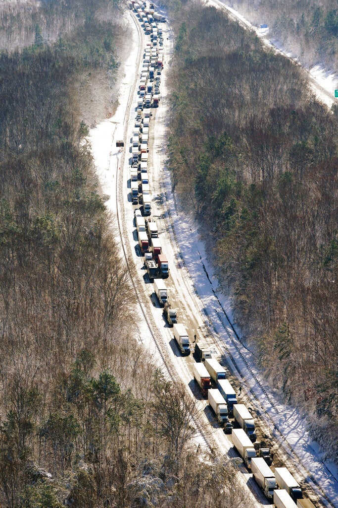 Cars and trucks are stranded on sections of Interstate 95, Tuesday, Jan. 4, 2022, in Carmel Church, Va. Close to 48 miles of the Interstate was closed due to ice and snow. (AP Photo/Steve Helber)