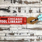 A red sign on a weathered-wood wall. The sign has white lettering that says Chicago Tool Library, and there is a black and white screwdriver jutting out from it on a blue comic-like, jagged edge background.