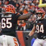 Cincinnati Bengals' Sam Hubbard (94) reacts with Larry Ogunjobi (65) after Hubbard sack Las Vegas Raiders quarterback Derek Carr during the first half of an NFL wild-card playoff football game, Saturday, Jan. 15, 2022, in Cincinnati.