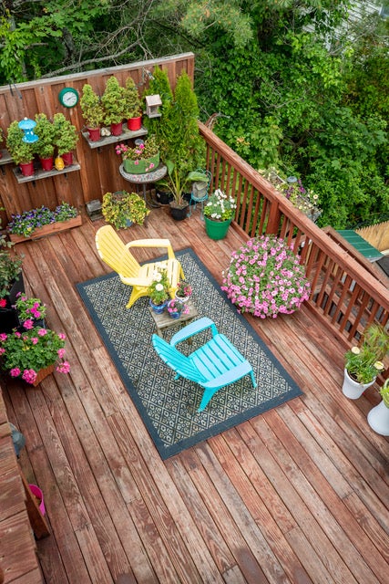 Looking down over a deck lined with potted flowers.