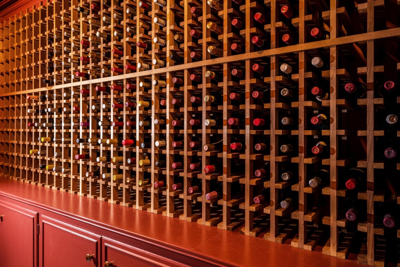A wooden win rack with room for hundreds of bottles of wine.
