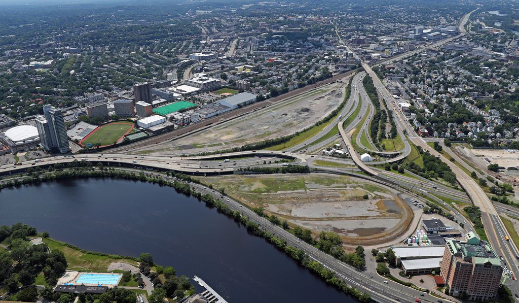 An aerial view of the Allston trainyards and the Charles River on a sunny day.