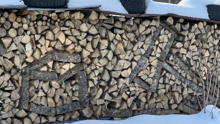 A woodpile in which wood laid bark-side out resembles a maul hammer and a chopping block.