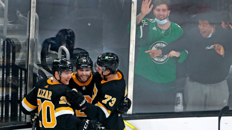The Boston Bruins celebrate a goal by Charlie McAvoy during the