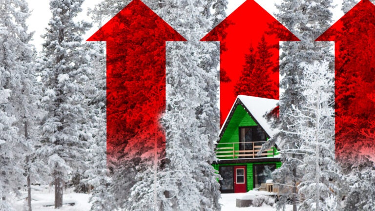 White Christmas in winter cabin in the woods between snow covered spruce trees. Red arrows in the background reach into the sky.