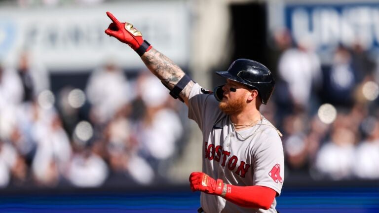 Red Sox outfielder Alex Verdugo is hit in the back by a baseball thrown by  a rogue fan