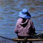 A wide brim hat was a nice fashion accessory to keep the sun off ones head while seated on a bench in the Boston Public Garden.