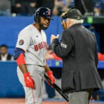 Jackie Bradley Jr. talks to umpire Larry Vanover