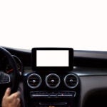 Driver’s hands on steering wheel isolated on white background
