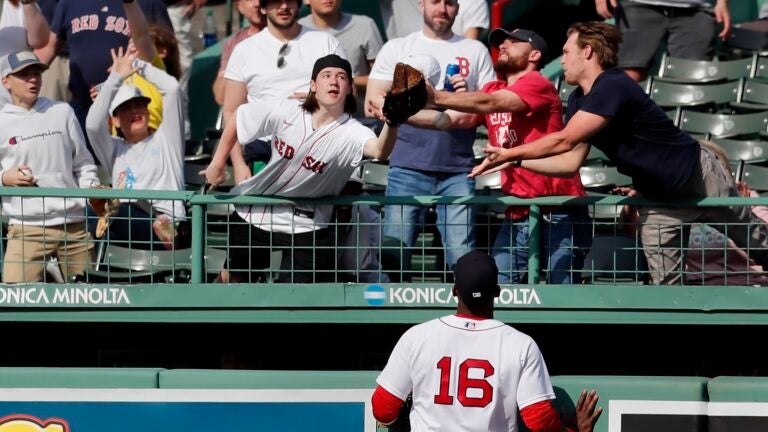Franchy Cordero of the Red Sox watches a home run soar over the bullpen.