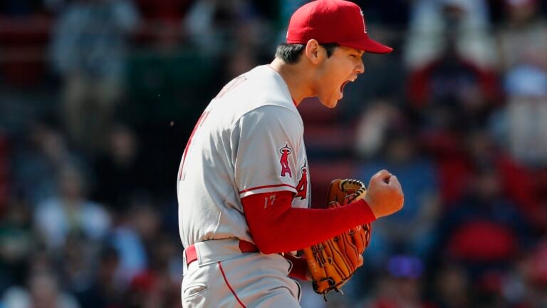 Shohei Ohtani of the Los Angeles Angels stands on first base after drawing  a walk in the ninth inning of a baseball game against the Boston Red Sox on  May 4, 2022