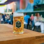 A half-liter mug of Jack's Abby beer sits on a patio table