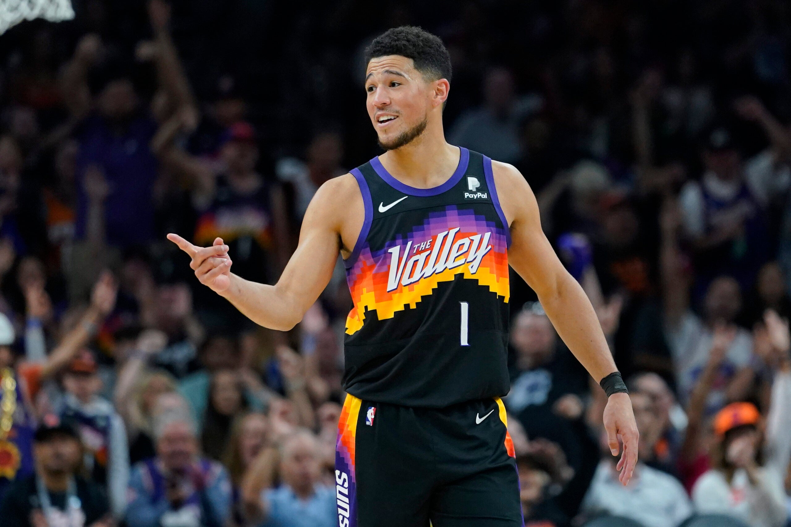 Phoenix Suns guard Devin Booker (1) reacts to a play against the Dallas Mavericks during the second half of Game 1 in the second round of the NBA Western Conference playoff series Monday, May 2, 2022, in Phoenix.
