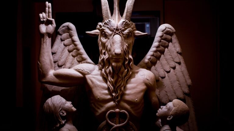 This 2014 photo provided by The Satanic Temple shows a bronze Baphomet, which depicts Satan as a goat-headed figure surrounded by two children.