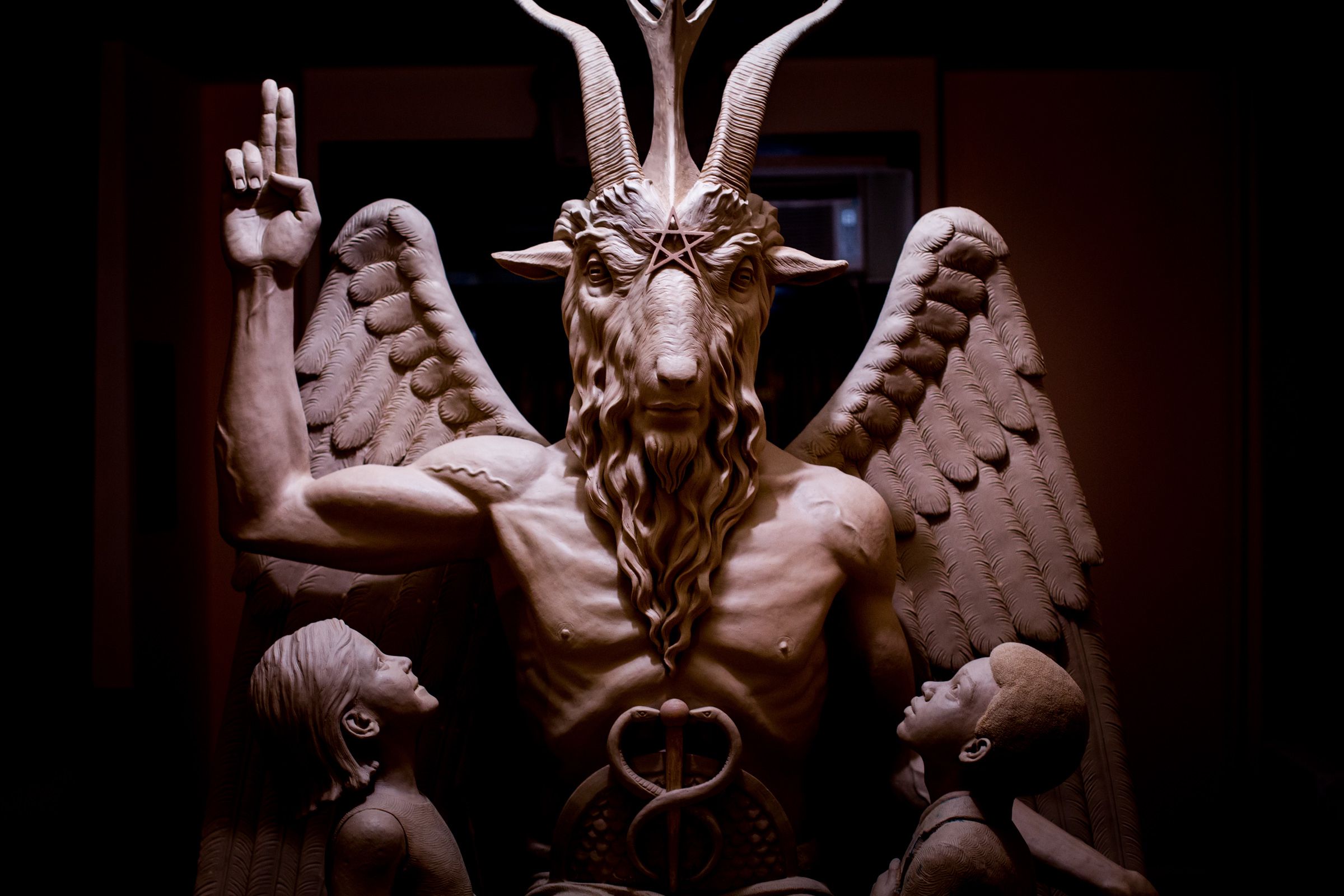 This 2014 photo provided by The Satanic Temple shows a bronze Baphomet, which depicts Satan as a goat-headed figure surrounded by two children.