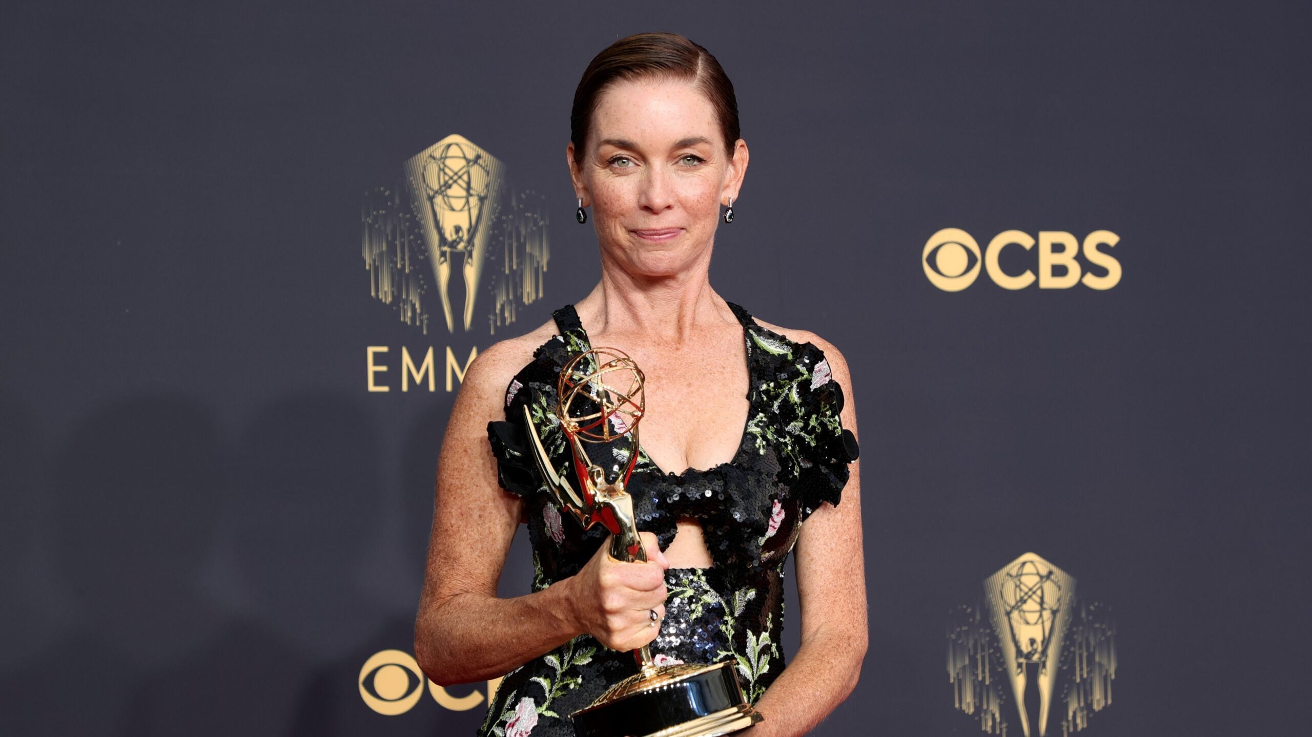 Julianne Nicholson holding her Emmy after winning for "Mare of Easttown."