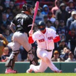 Rafael Devers strikes out, falls to one knee.