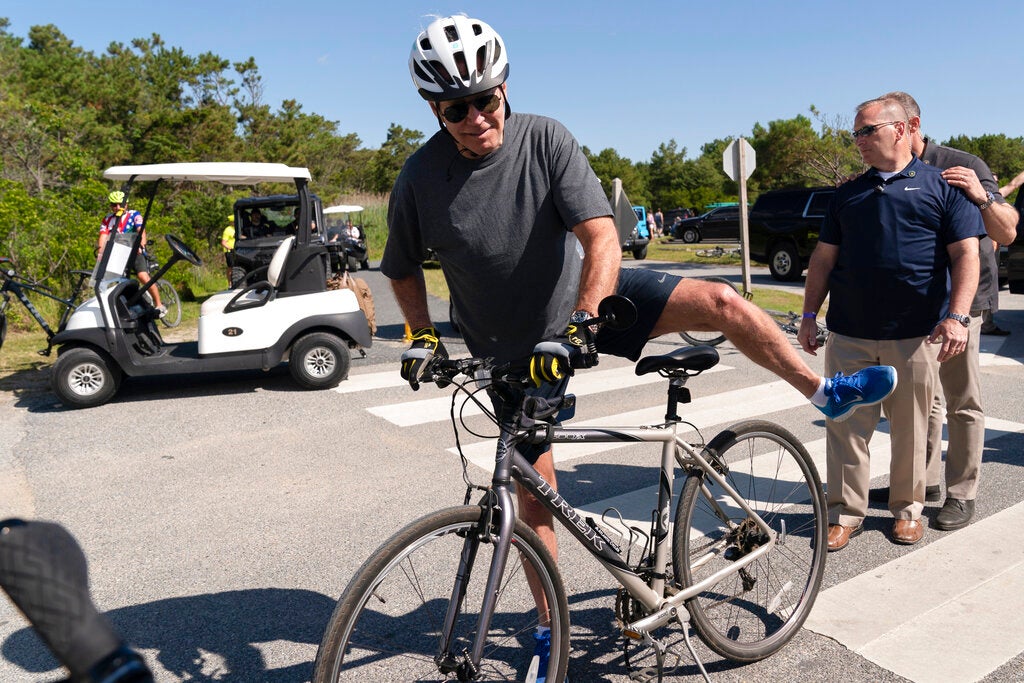 Biden takes spill while getting off bike after beach ride