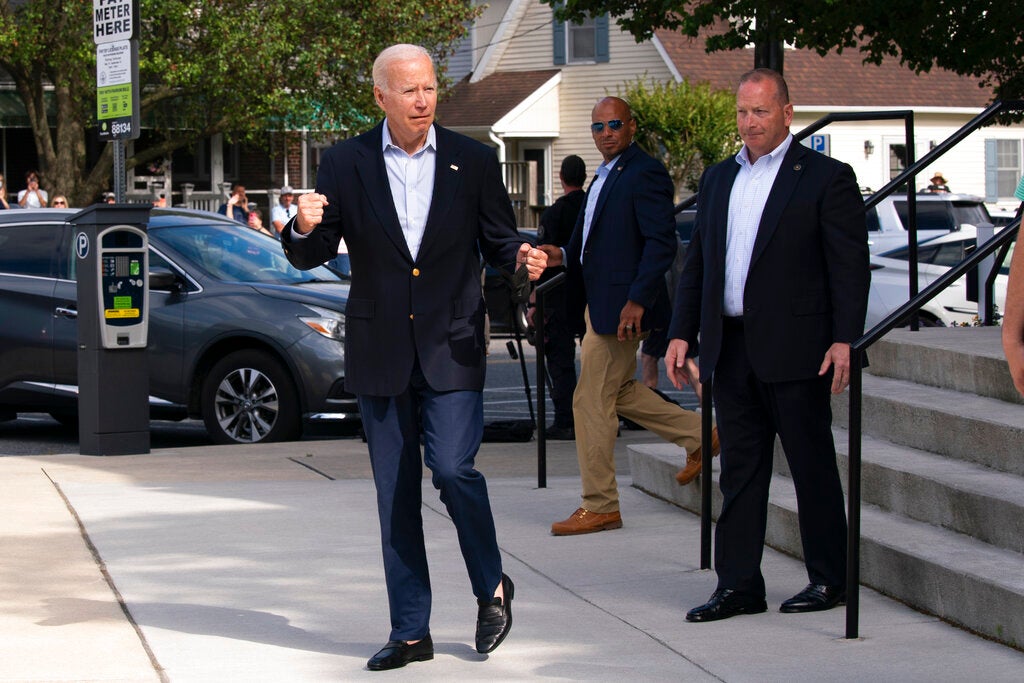 Biden takes spill while getting off bike after beach ride