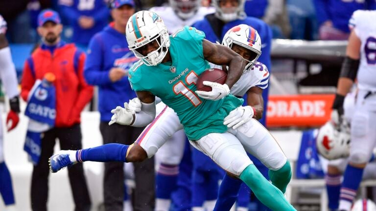 New England Patriots wide receiver DeVante Parker (1) catches the ball as  he practices on the field before an NFL football game against the Miami  Dolphins Sunday, Sept. 11, 2022, in Miami