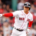 Rob Refsnyder points after an RBI single for the Red Sox