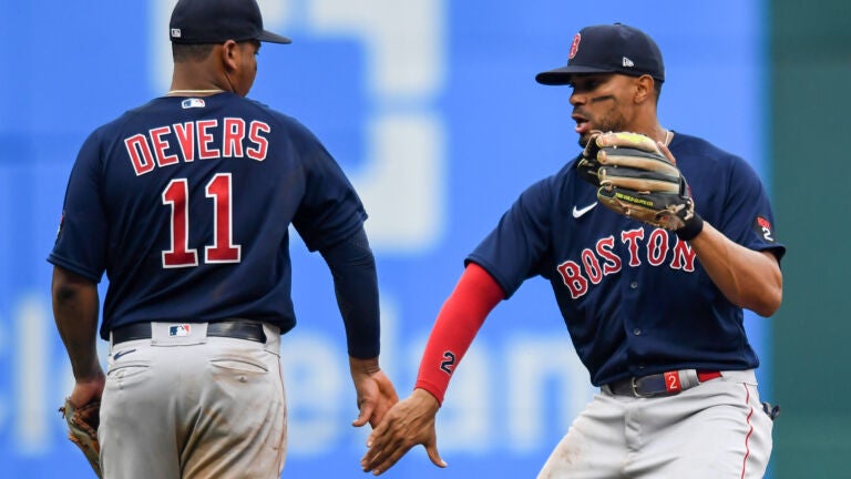 Rafael Devers of the Boston Red Sox is congratulated in the dugout News  Photo - Getty Images