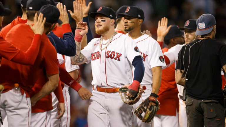 Red Sox celebrate in a line after Sunday's victory over New York.
