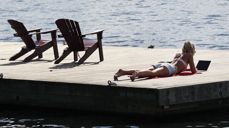 Boston weather -- , MA, 06/28/2022, Warm weather brought people out to the Esplanade to sun on the deck.