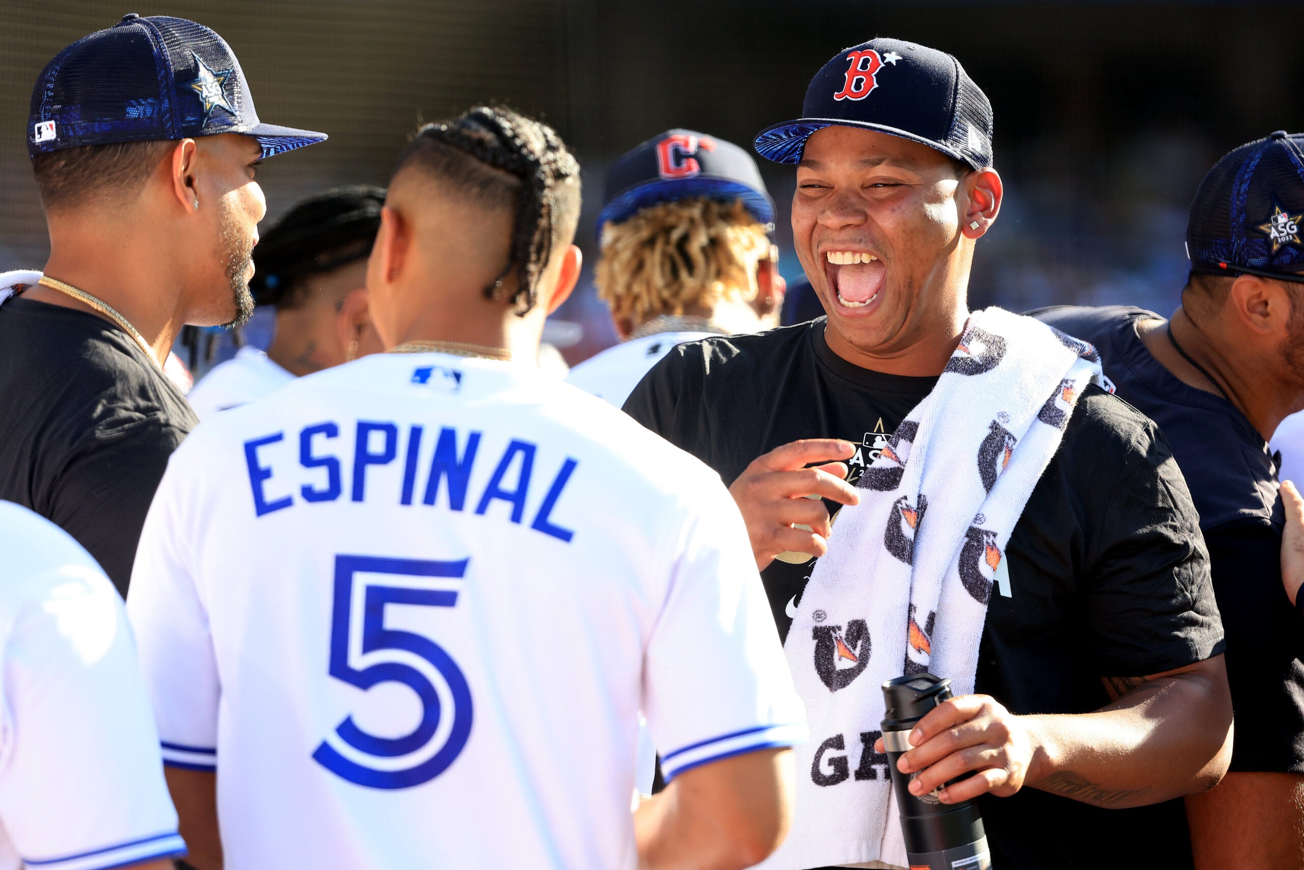 Rafael Devers laughs with Toronto's Santiago Espinal at the Home Run Derby.